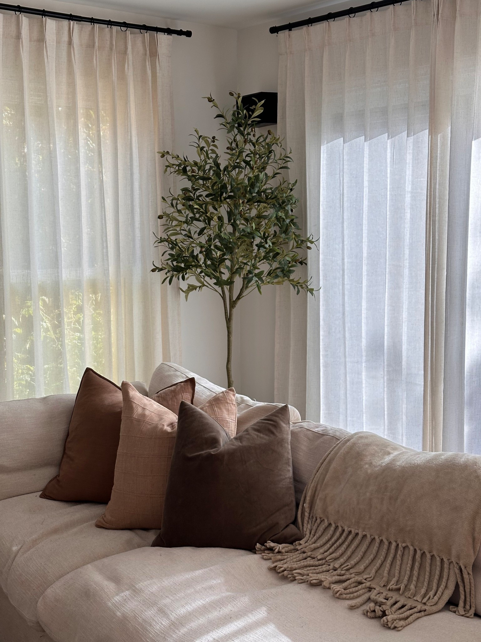 Cozy corner with faux olive tree and beautiful linen curtains , neutral tones 

#LTKSeasonal #LTKHome