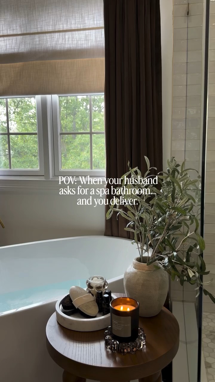 Spa bathroom ✅
Roman shades + curtains: @twopagescurtains 
Bathtub: @loweshomeimprovement 
Faucet: @amazonhome 
Table: @target 
Candle: @simplywhiskers 
Bubble bath dish: @alicelanehome 
Epsom salt: @drteals 
Tray: @allmodern 

Fun fact: My husband takes 3-4 baths a week 😂
#FrameYourMoment #TWOPAGESChallenge #twopageshome #spabathroom #bathroominspo