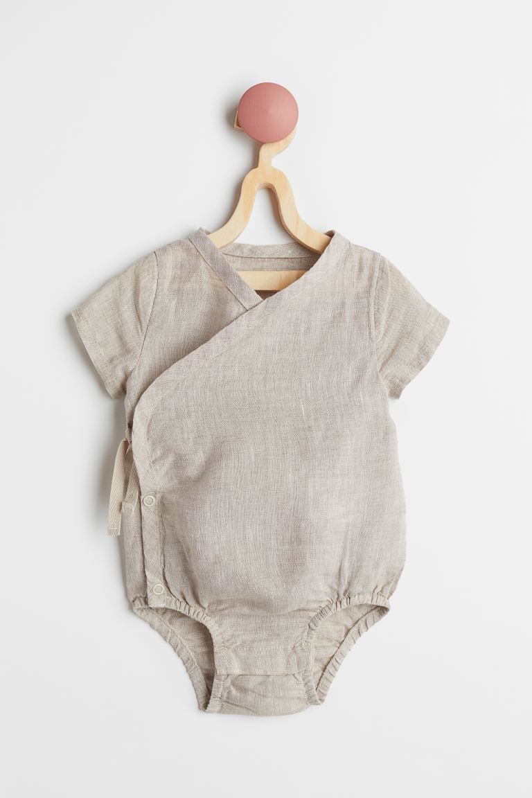 Baby Exclusive. Short-sleeved bodysuit in woven organic cotton fabric with ties at one side. Snap... | H&M (US + CA)