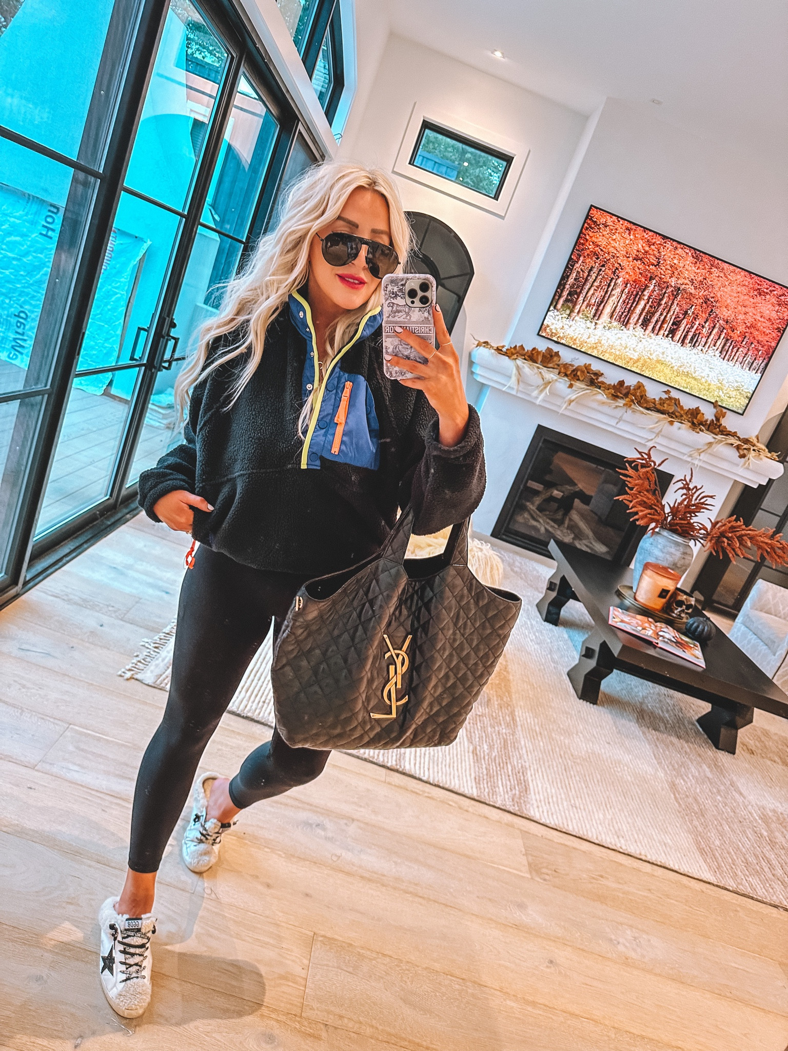 Wearing a medium in pullover and leggings 