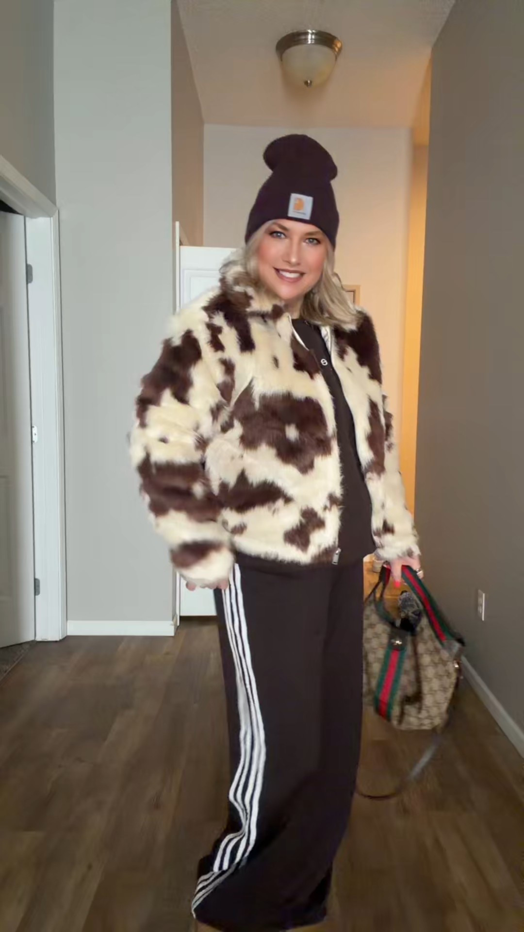 Such a cute cozy fur coat in this trendy cow print! #furcoat #cowprint #trackpants #ootd 

#LTKSeasonal #LTKootd