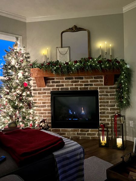 Cozy Christmas fireplace mantel with lanterns and pops of red! 

#LTKSeasonal #LTKhome #LTKHoliday