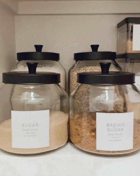 Pantry organization with glass jars with black lids, modern pantry labels you can customize, black baskets with wooden handles to corral things and make everything visible and accessible.

#LTKHome #LTKStyleTip