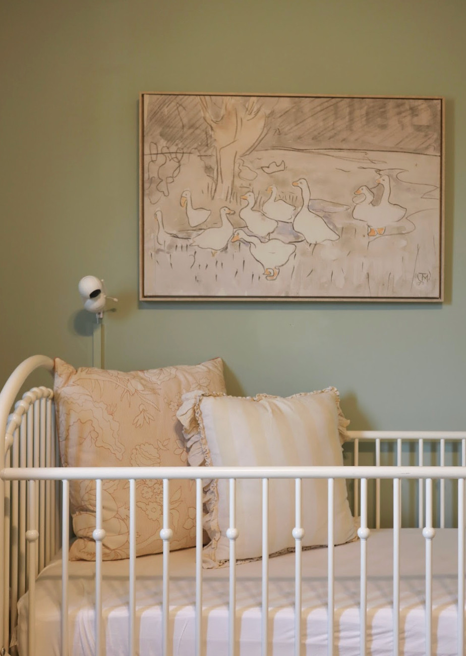 This sweet nursery is proof that feminine design doesn’t have to mean pink.✨ The parents wanted a space that felt timeless, unique, and full of charm, so we chose soft sage green walls and centered the design around a whimsical goose artwork that instantly became the heart of the room. Vintage-inspired furniture, cream and gold accents, and a cozy rocking chair added warmth and comfort, while a simple, functional layout with low bookshelves and a classic dresser ensures the space will grow beautifully with their daughter. The result is a peaceful, personality-filled retreat that feels both elegant and enduring.🕊️💚 

 #nurserydesign #vintagestyle #timelessinteriors #LTKU #LTKBaby #LTKFamily