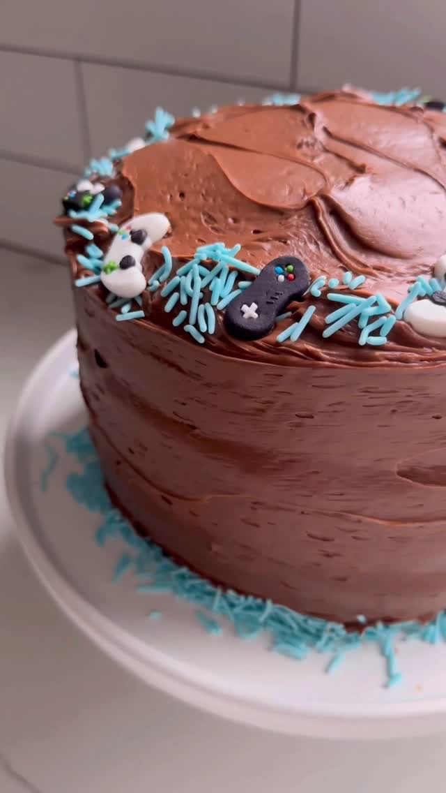 Let me take you on a trip to the 90’s and how we did Birthday Cakes in our home. My mom made one for my siblings + I each birthday and it is core memory requesting our favorite cake flavor each year 🩵

Affordable, delicious + nostaglic ✨

How I make my 3 Layer Chocolate Cake… 

🩵90’s Mom Birthday Boxed Cake🩵
2 boxes @bettycrocker Triple Chocolate Fudge Cake Mix
2 cups water
1 cup melted butter
6 eggs
3 cans @bettycrocker chocolate frosting 

Preheat the oven to 350°
Grease three 9” cake pans with butter and line the bottom of the pan with parchment paper too 

🩵In a mixing bowl, add the 2 boxes of cake mix, water, melted butter and eggs
🩵Mix together until the cake batter is smooth without clumps
🩵Divide the batter evenly amongst the 3 cake pans and bake according to the package for a 9” cake pan 

🩵Let the cakes cool for 5 minutes and then flip the cakes carefully out of the pans and allow to cool completely on a wire rack before frosting 

To frost:
🩵Add a generous, and I mean generous dollop into the center of the first cake layer 
🩵Use the back of a spoon 🥄 and gentle spread out the frosting moving the excess towards the edges (it’s OK for this to fall over the edge)
🩵Add the 2nd layer, repeat frosting steps
🩵Add the 3rd layer, repeat frosting steps 
🩵Use a butter knife and section by section add frosting vertically to the sides of the cake. The frosting that poured over the sides will fill the space between the layers perfectly!
Decorate as you wish! 

Congrats, you’ve just made an incredible 3 layered cake for a 90’s childhood dream!
