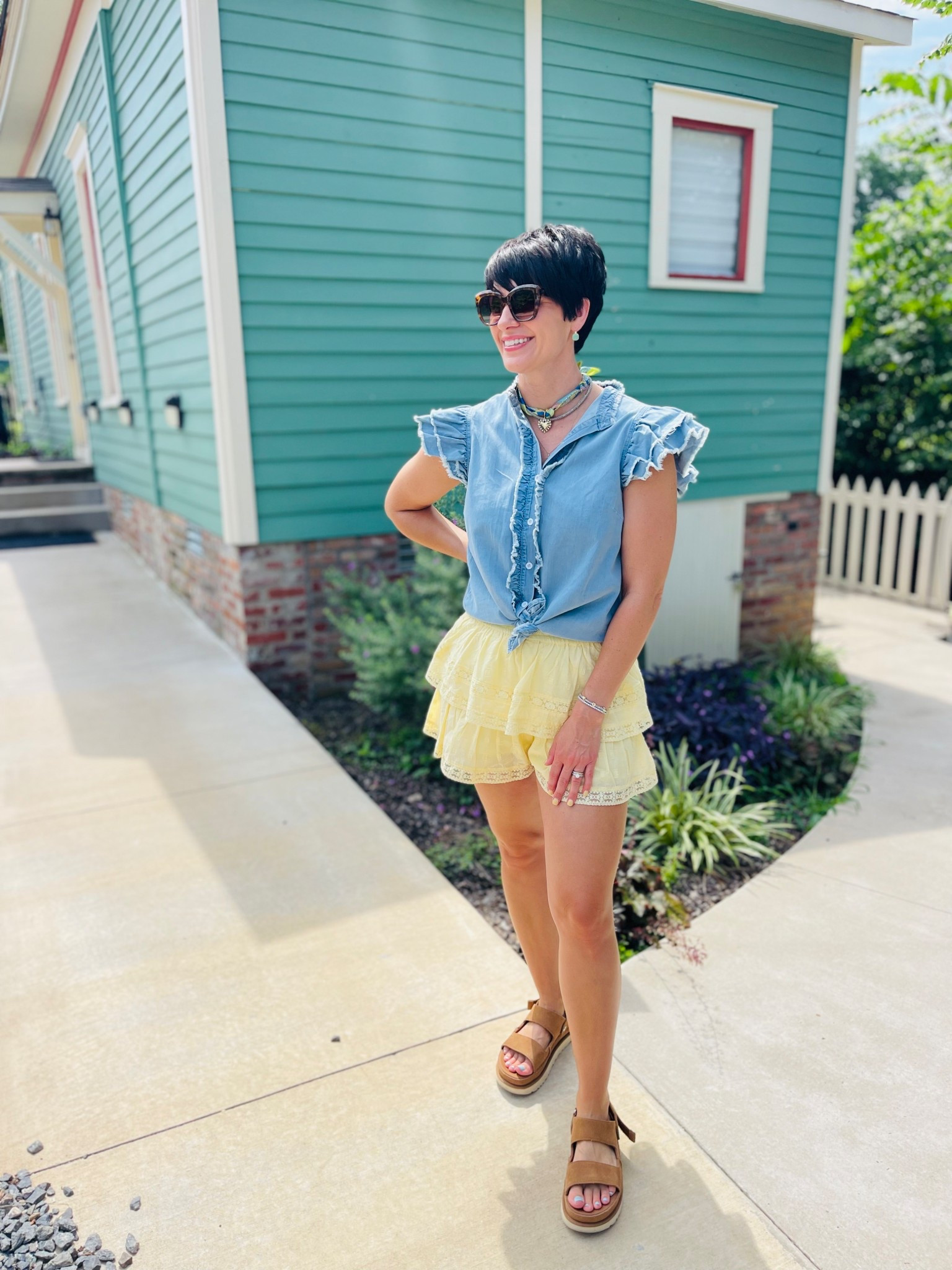 My outfit matched perfectly with the houses around our Airbnb! 😄
This denim top is a closet staple. It pairs with so many different looks, and I’m loving the ruffle detail! I tied it here, but you definitely don’t have to…I just liked this look best with my skirt 🥰

#LTKU #LTKSummerEdit #LTKStyleTip
