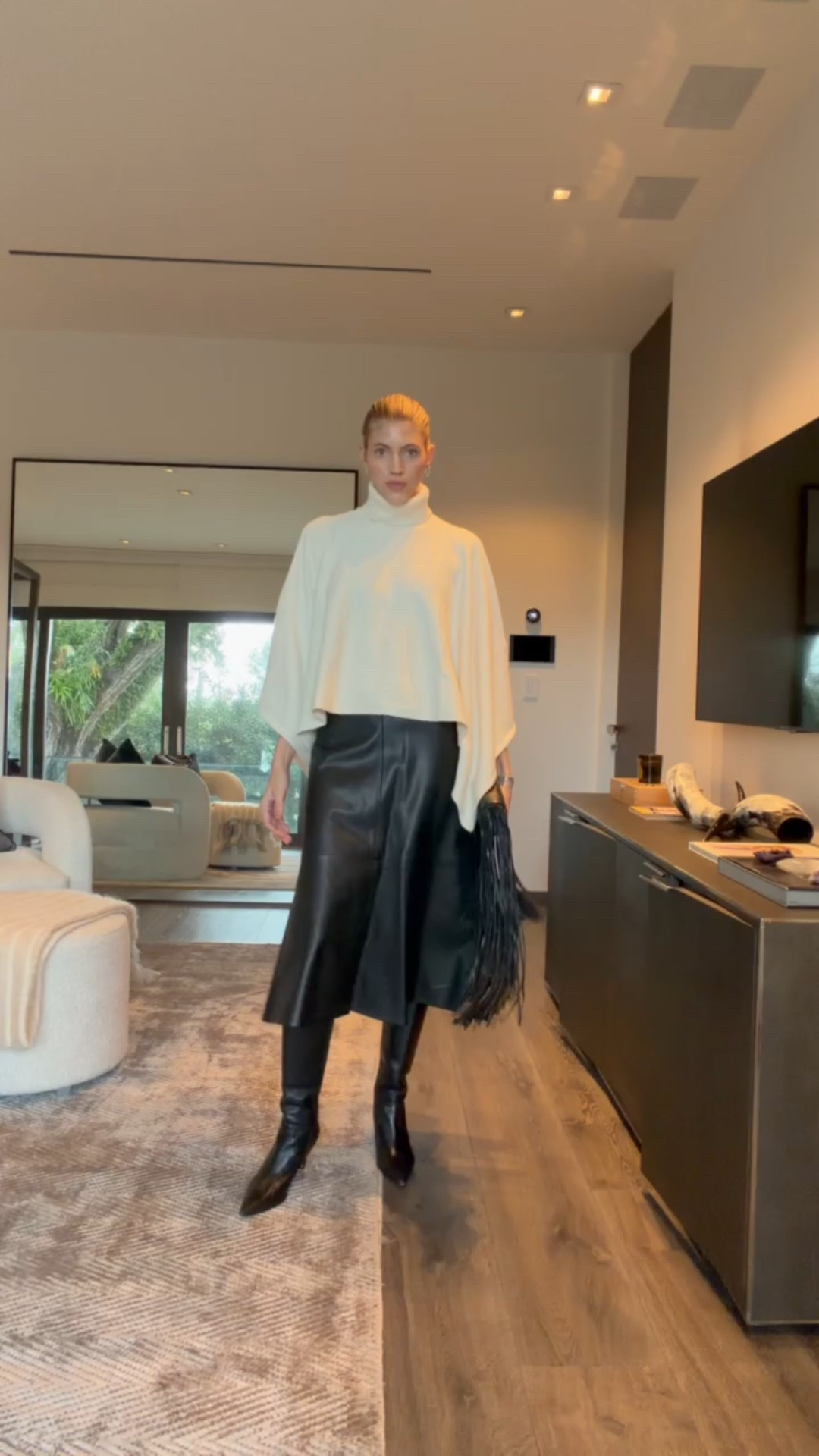 Next look is this super cool turtleneck cape top!🤍 This is so chic and I love the shape. Paired it with this leather midi skirt and black fringe bag!

#LTKgrwm #LTKootd #LTKSeasonal