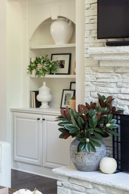 I use these faux magnolia branches throughout my home all year along. Here, I have seven branches in this large stoneware vase on my living room fireplace hearth. home decor living room decor faux magnolia stem faux floral built in styling alabaster white paint

#LTKhome #LTKstyletip #LTKunder50