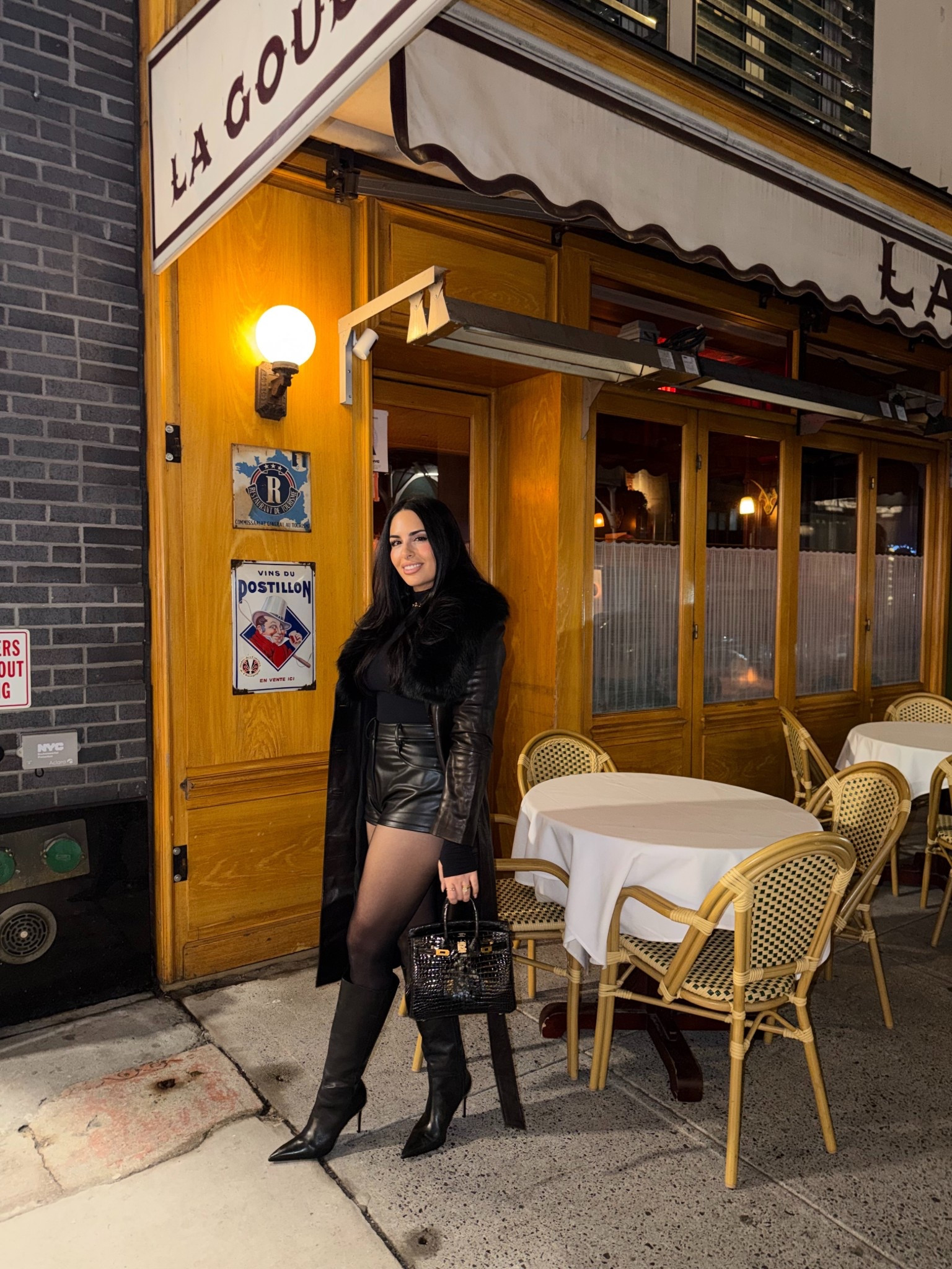 Leather shorts, leather boots, leather trench coat, bodysuit, sheer tights 