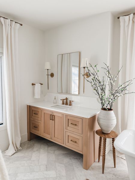 Bathroom vanity details! Gold details mixed with neutral wood tones and marble flooring. Minimal design showcasing bright and airy spaces

Home finds, bathroom details, faux florals, lighting detail, neutral wood tones, gold detail, linen curtain, bright and airy, vase finds, end table, neutral home, aesthetic home, Pottery Barn style, Wayfair, Joss and Main, gold hardware, light and bright, shop the look!

#LTKSeasonal #LTKhome #LTKstyletip