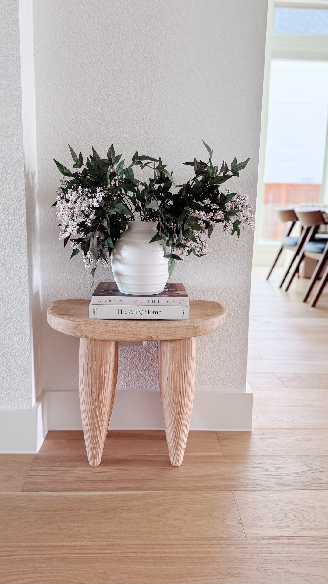 
Spring neutral home decor styling idea using a simple wood side table, stacked coffee table books, and a white vase with faux stems. This easy styling trick instantly elevates an entryway, hallway corner, or living room space while keeping the look minimal and organic. I linked the table, vase, stems, and decor pieces to recreate this neutral home vignette. People have been asking about this little table — it’s one of my favorite neutral decor finds.

#LTKHome #LTKspring #LTKvlog