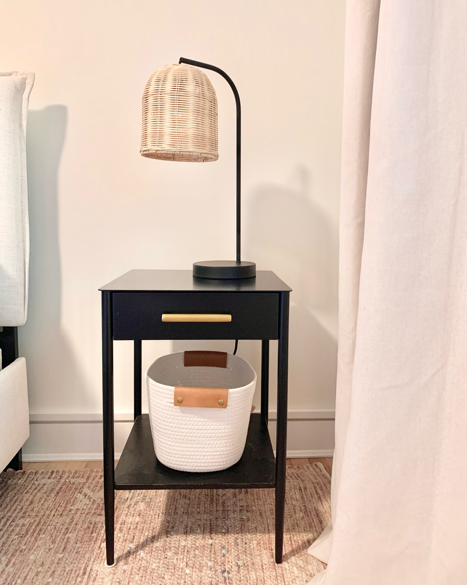 Mid-century modern end tables at the Chalet

Wicker table lamps
Black metal
Woven baskets
Curtains in Sour cream color
Area rug

#LTKhome #LTKunder50 #LTKunder100