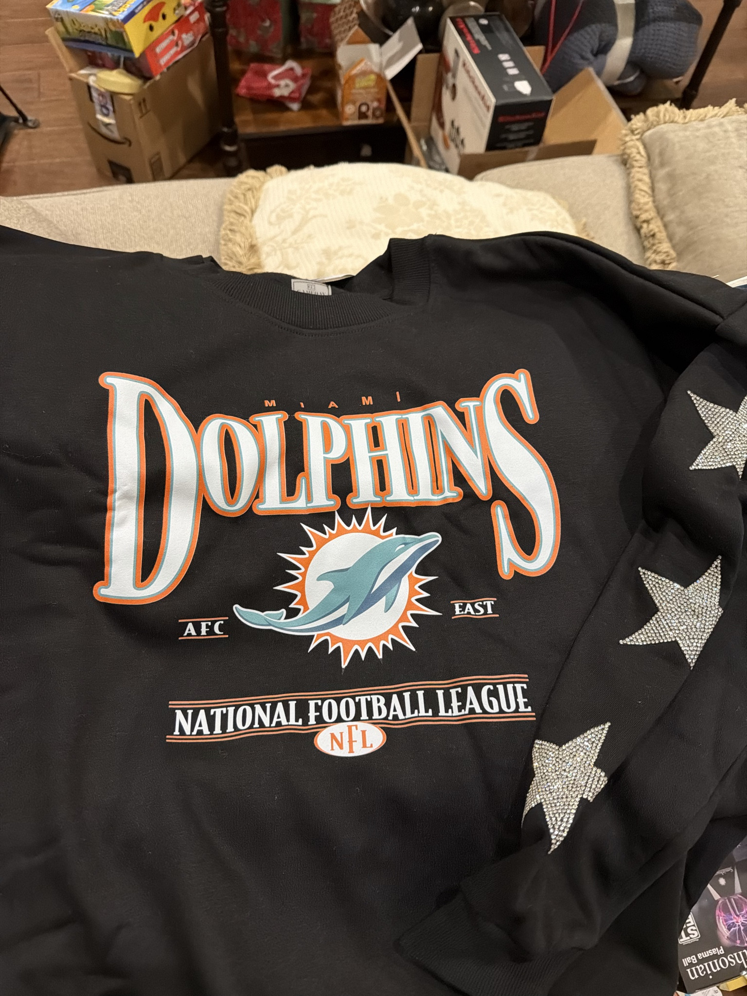 This Women’s Gameday Couture Black Miami Dolphins Pure Victory Rhinestud Star-Sleeve Pullover Sweatshirt is the ultimate football fan girl sweatshirt 🏈✨ 

It was a Christmas gift from my mom, and it truly screams football fam energy for the girlie pops who love stylish fan gear. The rhinestud star sleeves add JUST the right amount of sparkle while still keeping it cozy and wearable for game day, tailgates, or watching from home. 

Easy to style with jeans, leggings, or sneakers, this is such a fun way to rep the Miami Dolphins while staying comfy. 

Go sports! LOL

#LTKGiftGuide #LTKHoliday #LTKSeasonal