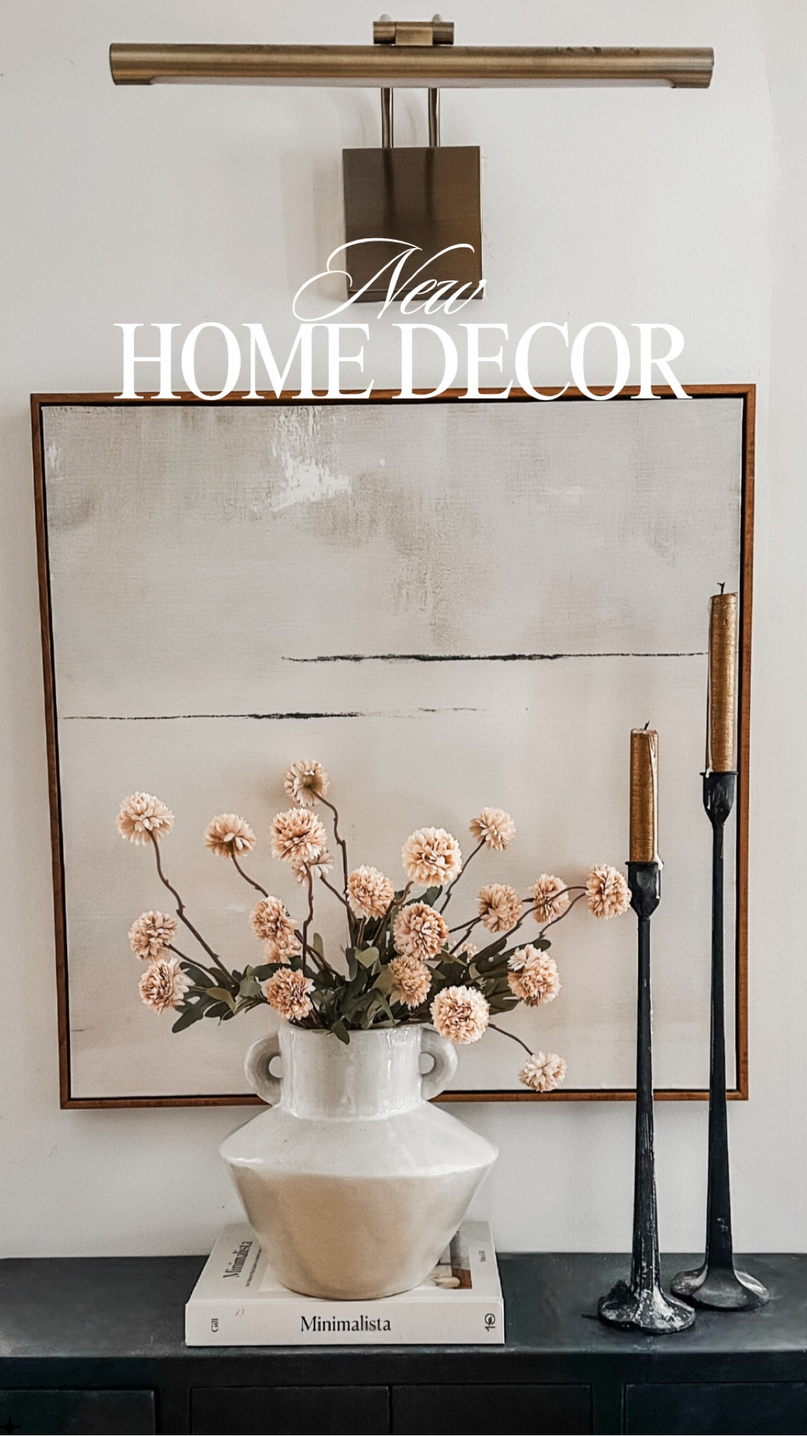 New timeless and romantic home decor for small little corners. I love blending modern abstract art with vintage vibes with the vase and faux dried flowers. Also loving this picture light! This is hard wired but I also have similar battery operated pictures lights in my home. 

🏷️ wall light // sconces // abstract art // vintage style vase // neutral case with handles // affordable faux flowers // artificial flowers // black candle holders

#LTKFindsUnder100 #LTKU #LTKHome