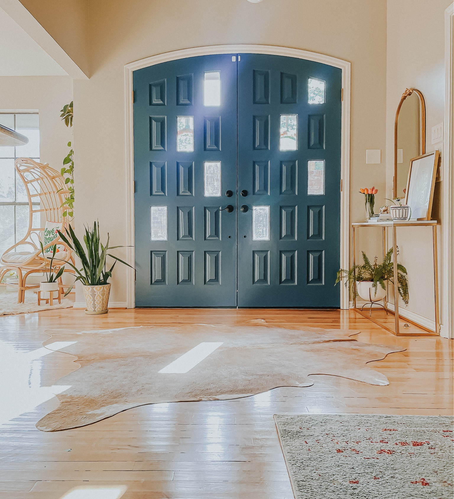 Front entry simple design inspiration and ideas. With an open concept entry it can be simple. 

Cowhide rug | cocoon chair | gold ornate mirror | snake plant | marble console tablee

#LTKfamily #LTKstyletip #LTKhome