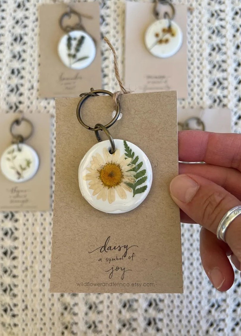 Carry a little piece of nature wherever you go 🌿 These real botanical key rings from WildflowerAndFernCo are handcrafted with pressed flowers and herbs gathered on a Pennsylvania farm, set in oven-baked clay and sealed with a glossy epoxy finish. Each one is thoughtfully made and comes with a handlettered card sharing the meaning behind the botanical, making it an extra-special gift. Perfect for lanyards, backpacks, or keys—and even better knowing they ship from Pennsylvania, keeping things closer to home. 🍃 #LTKfinds #EtsyGifts #BotanicalStyle #HandmadeWithLove #NatureInspired #EcoFriendlyGifts #SmallBusinessSupport

#LTKGiftGuide #LTKHoliday #LTKHome