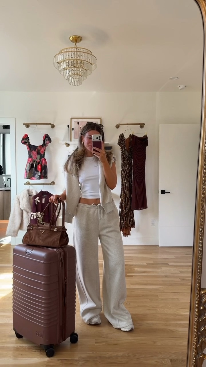 Grey wide leg sweatpants with white baby tee grey sweater and sneakers airport travel outfit 

Wearing small tops medium pants 

Cozy comfy
Loungewear
Airport look
Travel outfit
Luggage
Tan sneakers 

 #LTKStyleTip #LTKTravel #LTKSeasonal