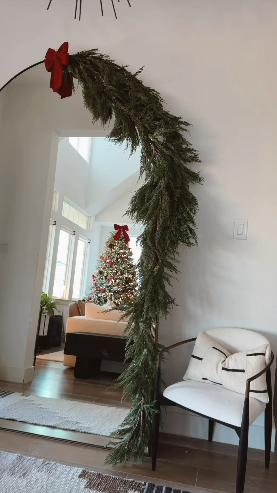 The best cypress garland that looks super realistic! I’ve had this garland since 2020 and the quality is great. I used three here on our oversized floor mirror to create this lush simple drape with a red bow on top. 

#LTKHoliday #LTKHome