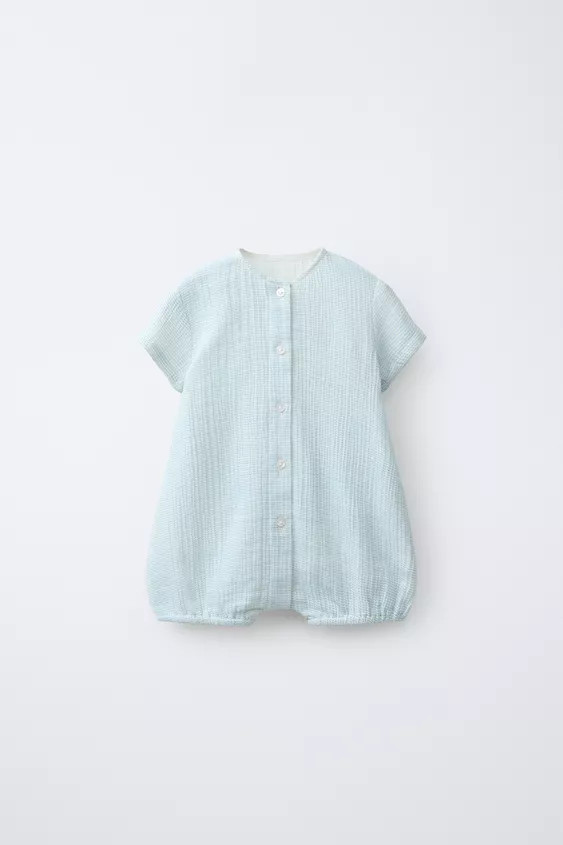 Romper with a round neck and short sleeves. Featuring front button fastening and elasticated hems... | Zara UK