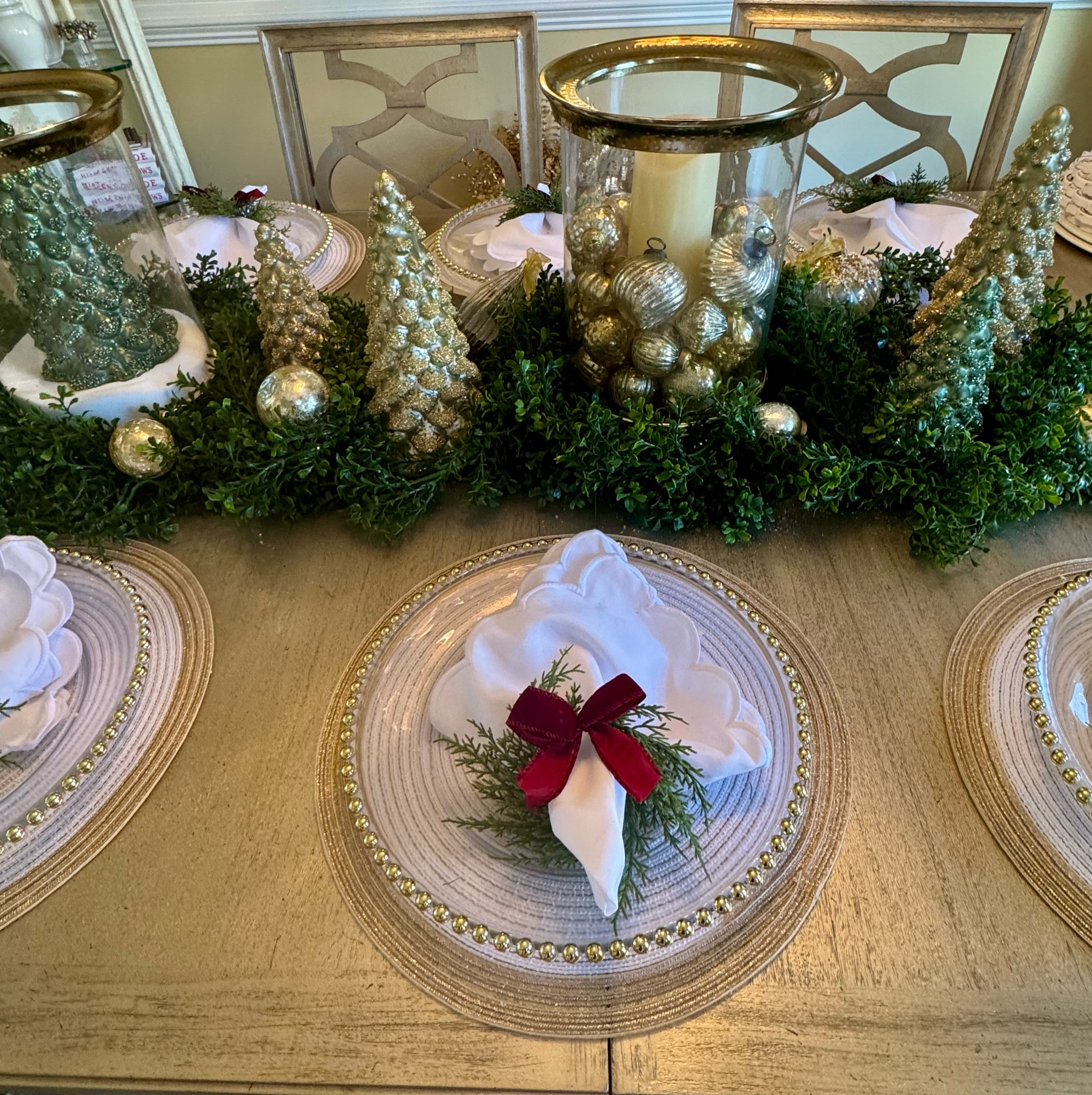 Elegant holiday tablescape featuring gold accents, lush greenery, and festive napkin details – perfect for a sophisticated Christmas gathering.

#LTKHoliday #LTKHome #LTKSeasonal