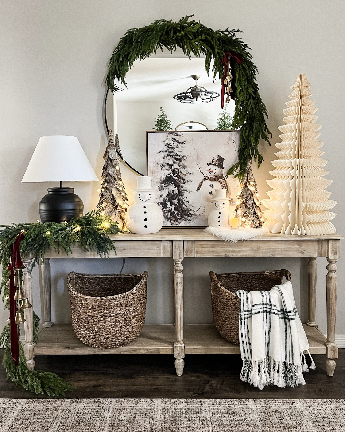 CHRISTMAS console styling!  Follow @lifeinmyarizonahome on Instagram for more holiday ideas and inspiration. 

I went for a fun whimsical look with this oversized paper tree and these adorable snowmen. I absolutely love these birch trees, that can be set on a timer, and this beautiful artwork helps complete the look!  

For reference:
Mirror garland used one 5ft Norfolk garland and 3 additional Norfolk stems. 
Artwork is in the 24x24 inch size.
The birch trees are the medium and small size. 
The table garland is a 6ft Norfolk garland with 3 additional Norfolk stems. 
The bells on the mirror are a simple DIY with 6 mini bells tied with jute string. 

#christmasdecor #homedecor #christmasstyling #consoletable #christmasentryway 


#LTKHoliday #LTKSeasonal #LTKHome