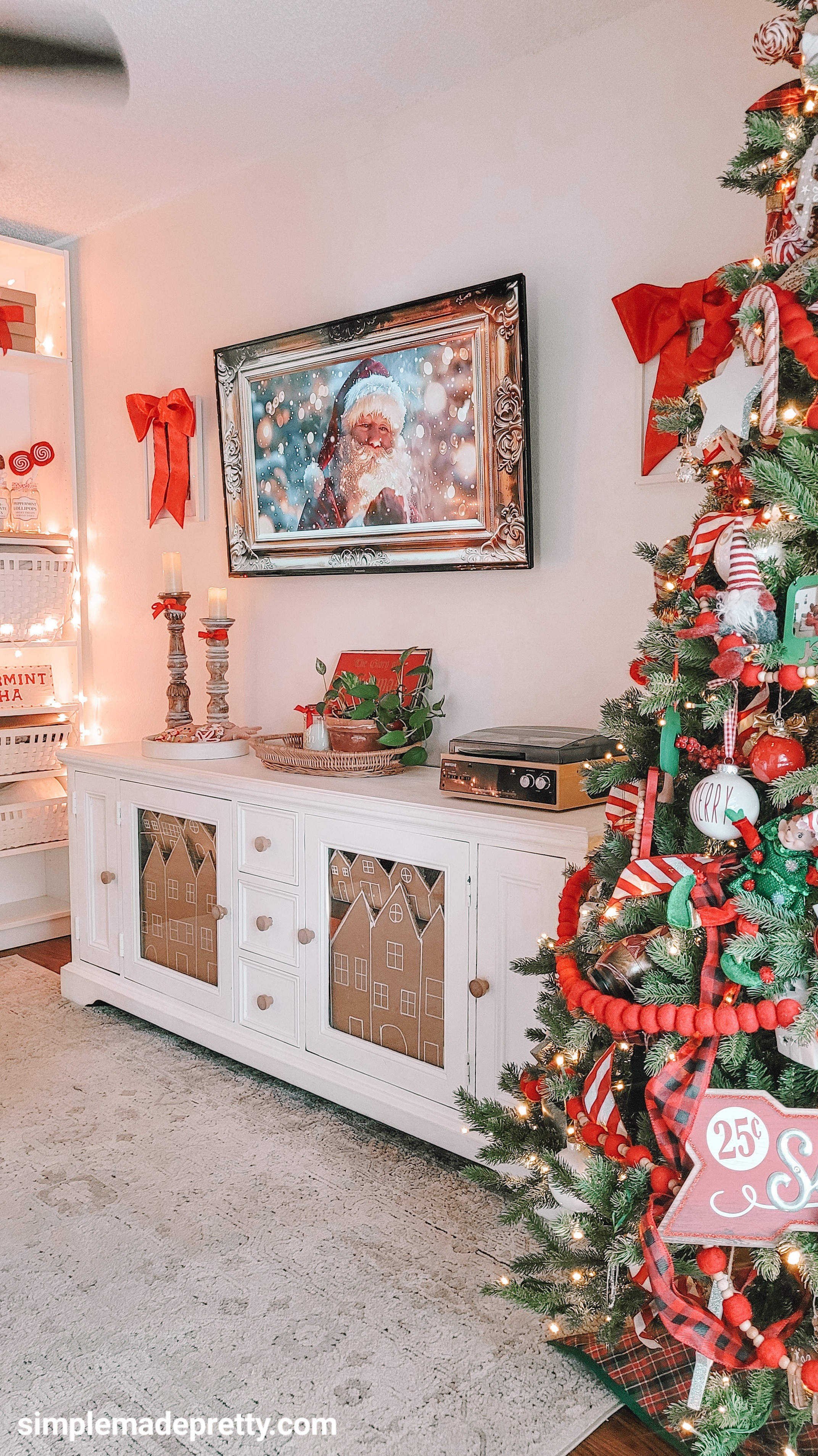 This little corner feels so nostalgic this year 🎄❤️
I added cardboard “gingerbread house” panels inside the cabinet doors (recycled + basically free!) and paired them with my Santa Frame TV art, cozy candles, and our peppermint tree.

Linked everything similar — the Frame TV art, candlesticks, rug, record player, tree décor, and all the gingerbread-inspired pieces I could find 👇✨#christmasdecor #cozychristmas #holidayhomedecor #christmashometour #gingerbreadchristmas #dollartreediy #christmasinspiration #holidaydecorideas #budgetdecor #festivehome #simplemadepretty #christmashome #christmaslivingroom #holidaystyle #diychristmasdecor
 

 #LTKHoliday