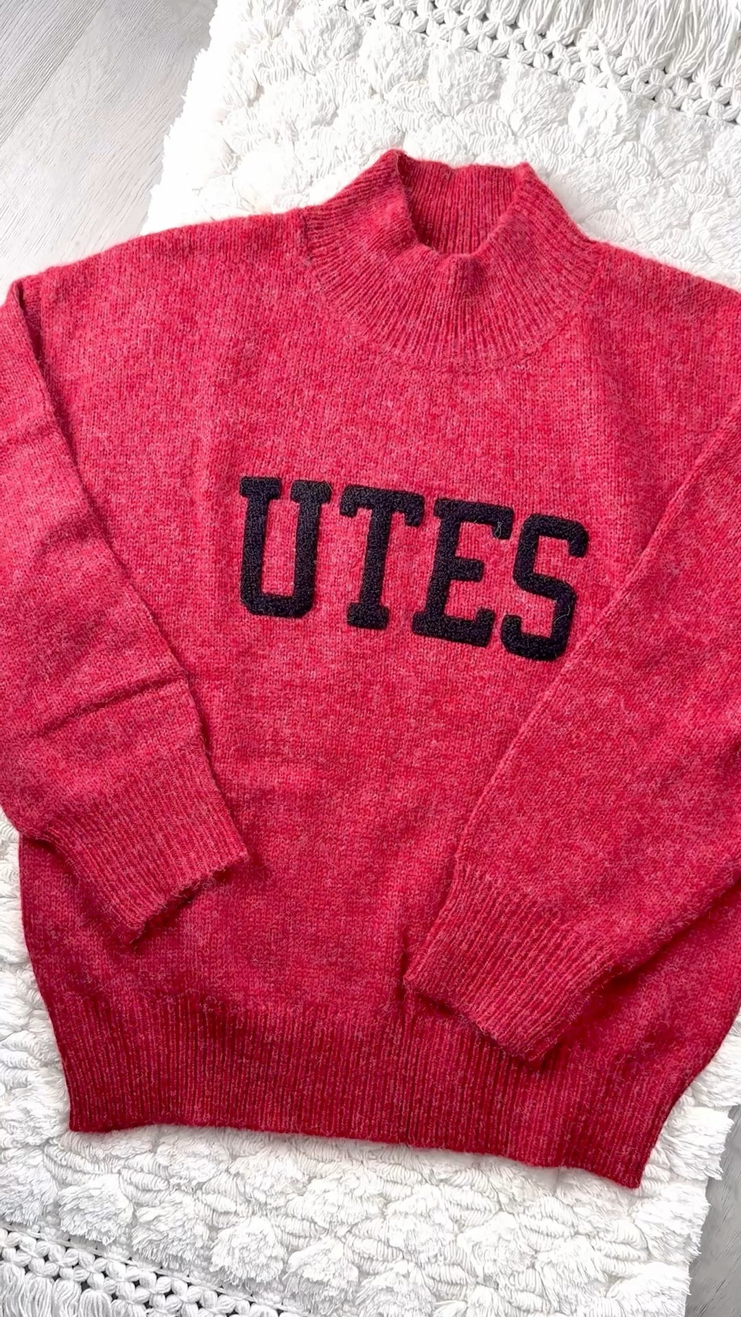 This cozy “UTES” mock neck sweater is that perfect mix of classic + elevated. The rich, heathered red is insanely flattering, the bold black lettering pops without feeling overly sporty, and the relaxed, slightly slouchy fit gives it that effortless, model-off-duty vibe. The chunky ribbed collar, cuffs, and hem make it feel high-end and extra warm for those chilly stadium nights.

I’ve collected way too many pieces at this point, and every single one is soft, flattering, and made to actually be worn on repeat.
Fabric feels soft (not itchy), warm without being heavy, and lays beautifully without clinging. It’s the kind of sweater you can dress up or down — and yes, it looks just as cute after game day for brunch, errands, or travel.

I love styling it with:
• Black leggings + sneakers or boots for game day
• Straight-leg denim + a baseball cap for casual days
• A leather or puffer jacket layered on top for colder temps
• Gold hoops + slicked-back bun for that effortless vibe

And the best part — they have SO many other colleges too, so whether you’re a Utah girlie or cheering for another team, you can find the same elevated style for your school.

A must-have for football season, basketball season, and all the cozy months in between. 

Utah Utes • U of U Style • Go Utes • UTES • Game Day Outfit • College Game Day • Collegiate Style • College Fashion • Sporty Chic • Neutral Style • Fall Outfits • Winter Outfits • Cozy Season • Mock Neck Sweater • Statement Sweater • Oversized Sweater • Athleisure Style • Campus Style • Street Style Inspo • Football Season Style • Stadium Style • Tailgate Style • College Outfits • Elevated Casual • Fan Gear • College Merch • Game Day Style • College Must Haves

#LTKGiftGuide #LTKootd #LTKFindsUnder100