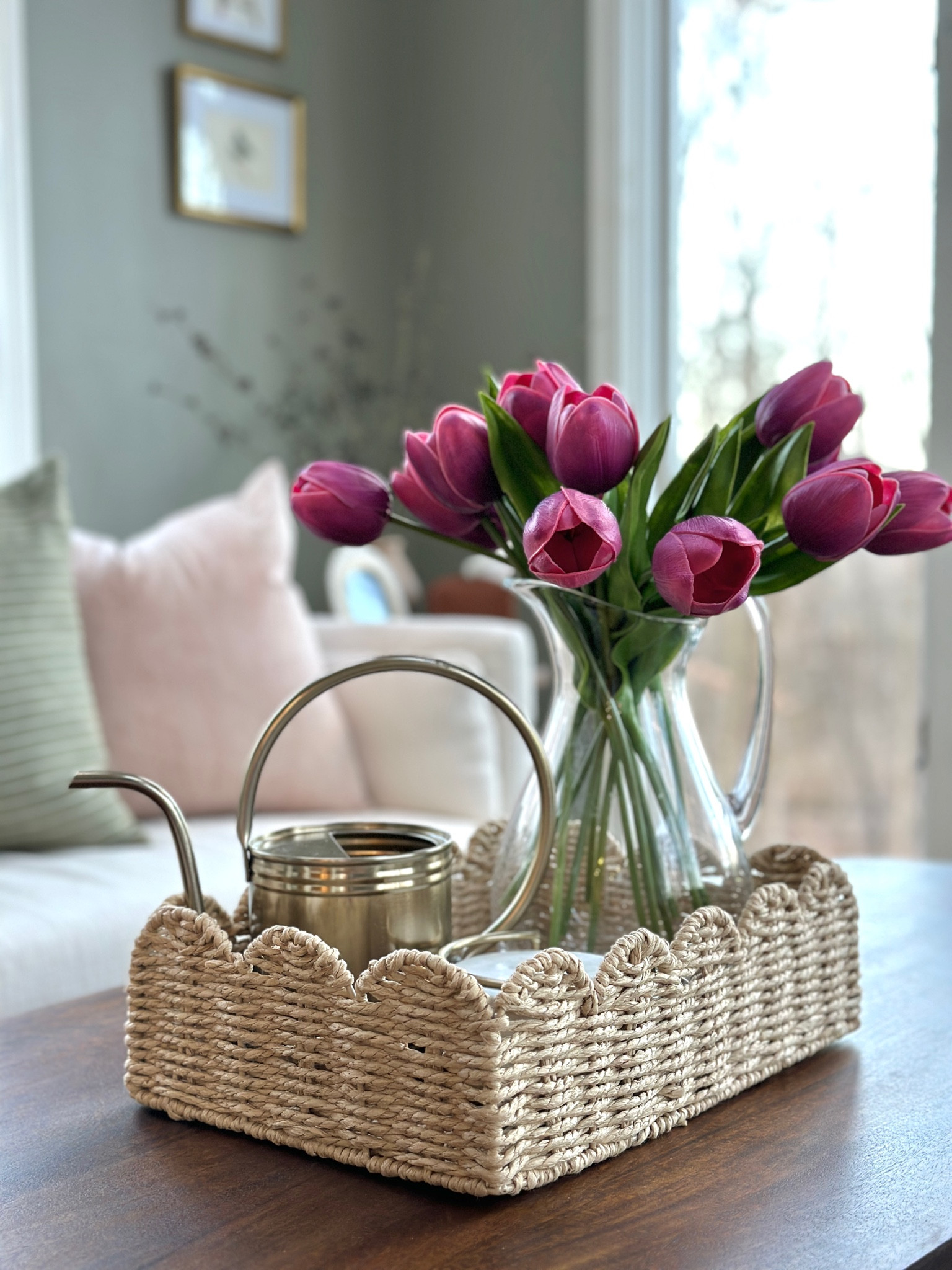 Spring florals, sunroom decor, faux tulips, glass vase, watering can, beige sofa, cream sofa, white sofa, wicker tray, scallop
