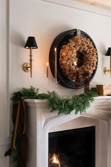 Traditional fireplace holiday decorating… a little garland, candles, and a textural pine cone wreath. 

#LTKSeasonal #LTKhome #LTKHoliday