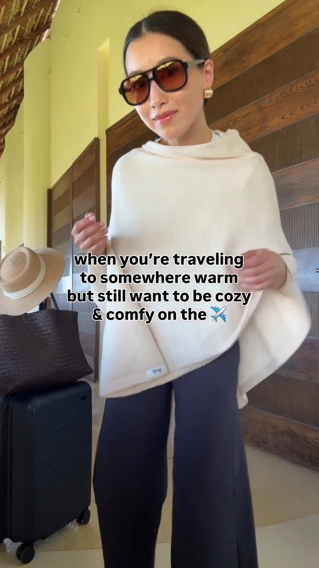 On sale: Lightweight poncho color name is “beige” and is off white. This Travel outfit also looks good with any sneakers!

• Aritzia trousers 2XS short, runs long for petites but fabric is amazing and doesn’t wrinkle

• Amazon poncho sweater scarf wrap “beige” thinner weight but good for planes and warmer destinations 

• lululemon crop t-shirt

• Dolce Vita jelly flats size 5, size down if you're a half size

• Madewell woven leather tote - My favorite work / mom / travel bag that fits my laptop and much more

• Madewell aviator sunglasses

• Amazon packable sunhat with an adjustable inner fit. I’ve owned this for years 

• Away the bigger flex carry-on suitcase, lightweight, roomy size and durable. I've traveled a lot with this.

Petite friendly travel outfit, family vacation,  easy mom outfit