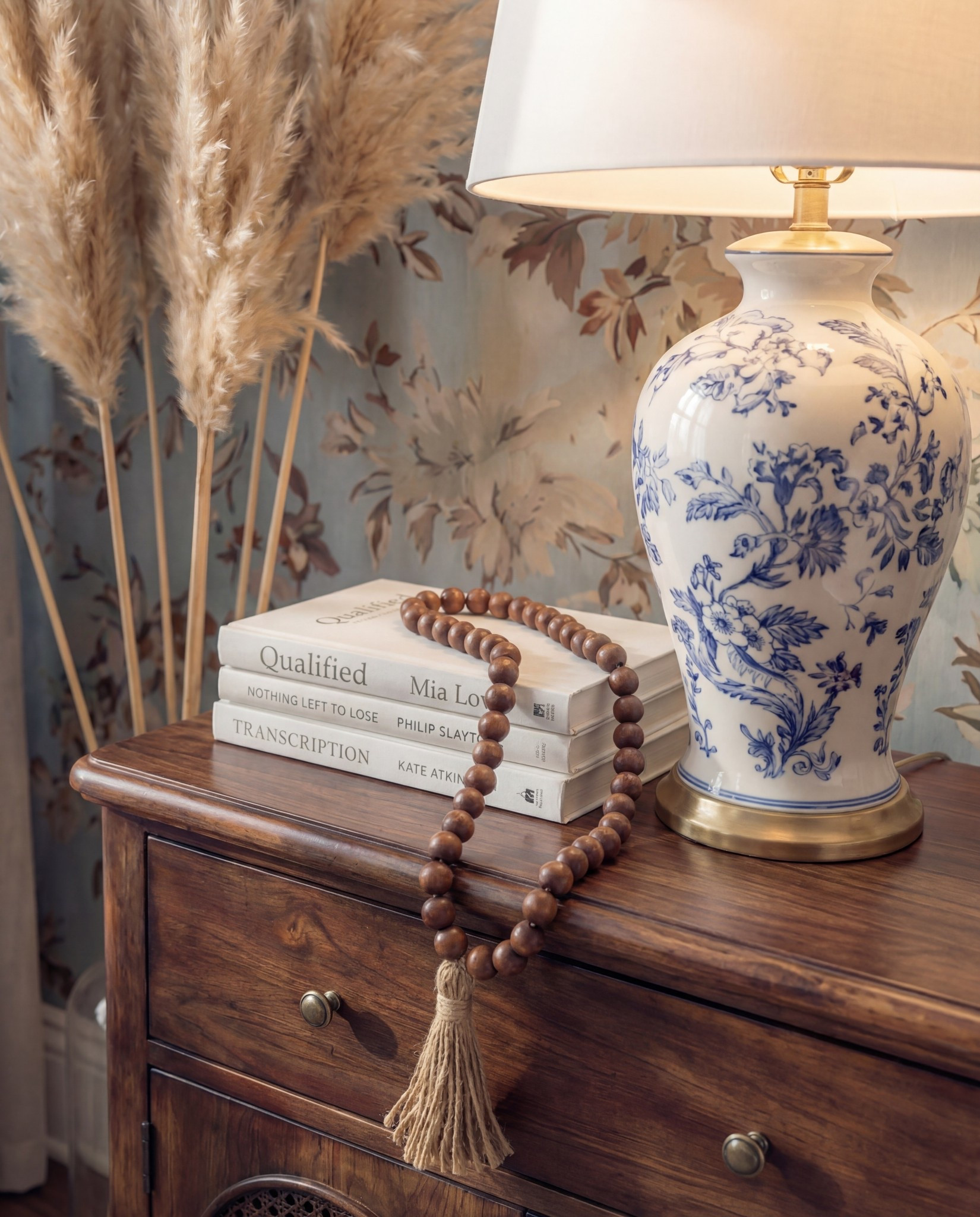 Shop the Look:
• Blue floral wallpaper
• Dark wood bed frame
• Chunky knit blue throw
• Blue patterned area rug
• Cream upholstered bench
• Blue + cream accent pillows
• Chinoiserie-style ceramic table lamps
• Pampas stems for softness
White decor books
Brown decor beads 

#LTKHome #LTKFindsUnder100 #LTKSaleAlert