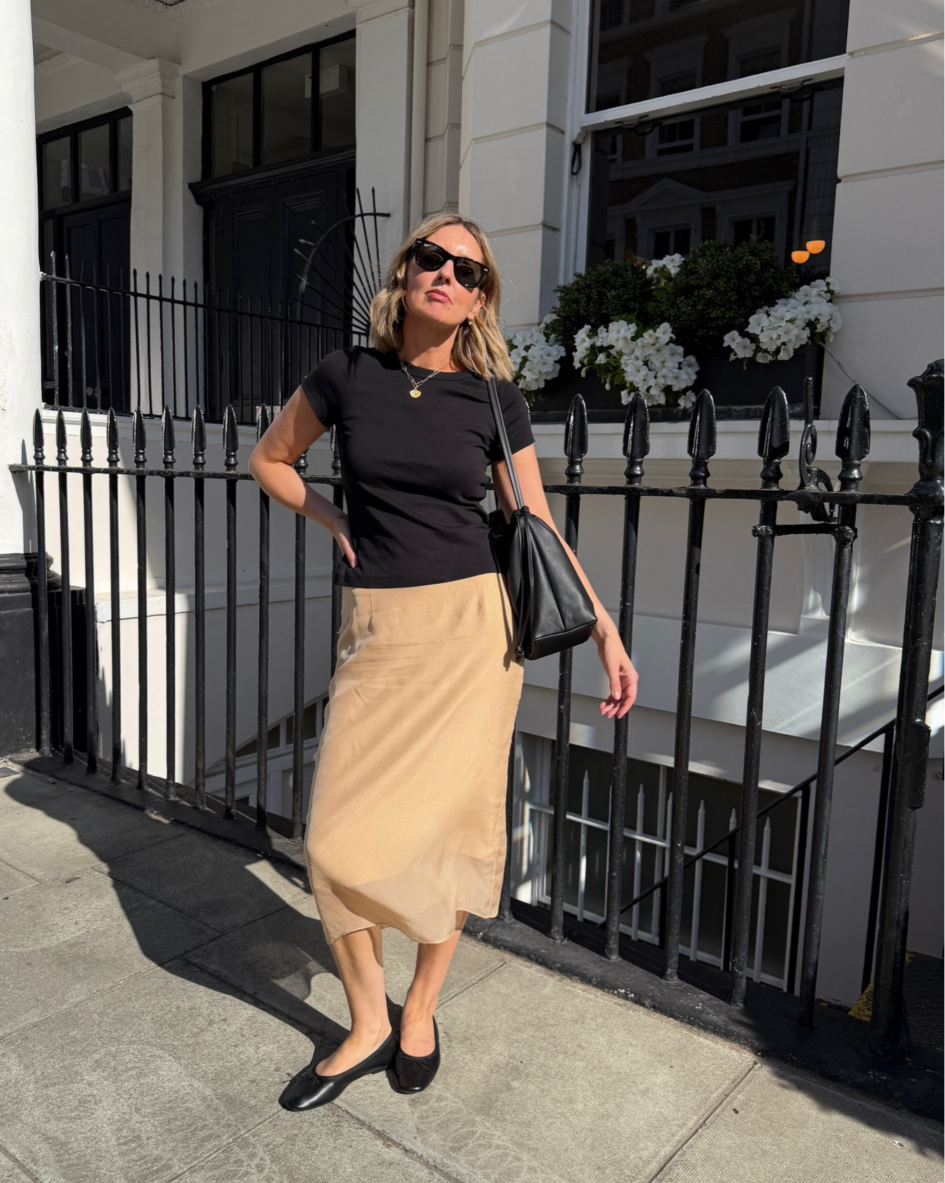 black fitted t-shirt, black crew neck top, camel silk skirt, tan slip skirt, midi skirt, black bow ballet flats, black slouchy shoulder bag, gold pendant necklace, layered gold jewelry, black sunglasses, city outfit, London street style, monochrome outfit, transitional dressing, quiet luxury, elevated basics, effortless chic, ltkstyletip, ltkseasonal, ltkfindsunder100, outfit inspo, capsule wardrobe essentials

#LTKdatenight #LTKsummer #LTKworkwear