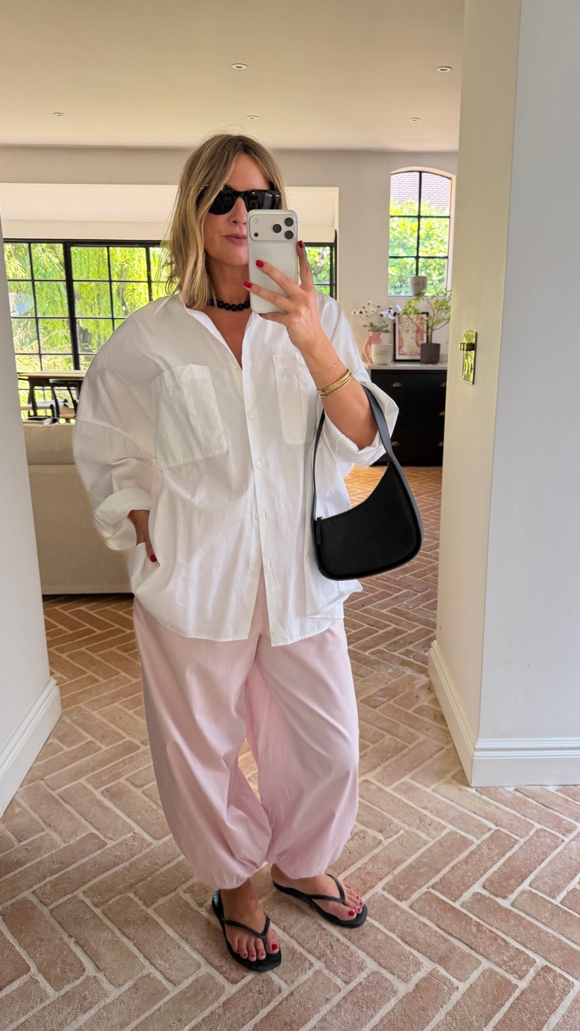Pink balloon trousers + oversized white shirt + flip flops + black bag

#LTKuk #LTKsummer #LTKeurope