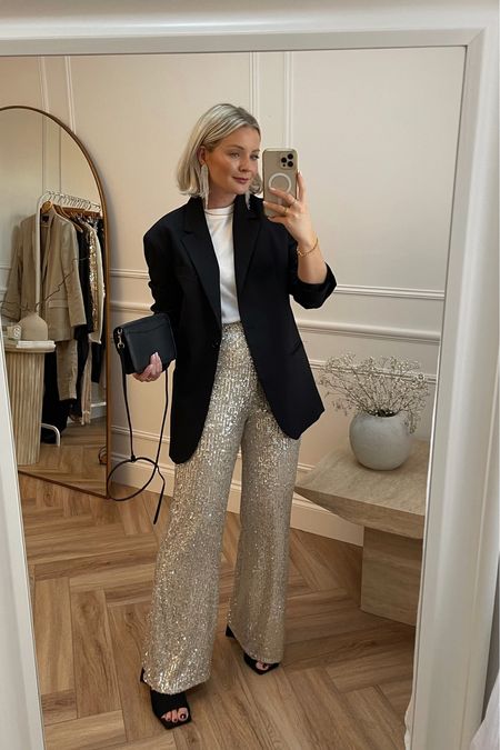 Festive partywear outfit inspiration. Sparkly silver sequin trousers from new look paired back with a white t shirt from cos, arket black blazer, black heeled mules, small pebble coach bag & sparkly drop earrings from H&M

#LTKSeasonal #LTKHoliday #LTKstyletip