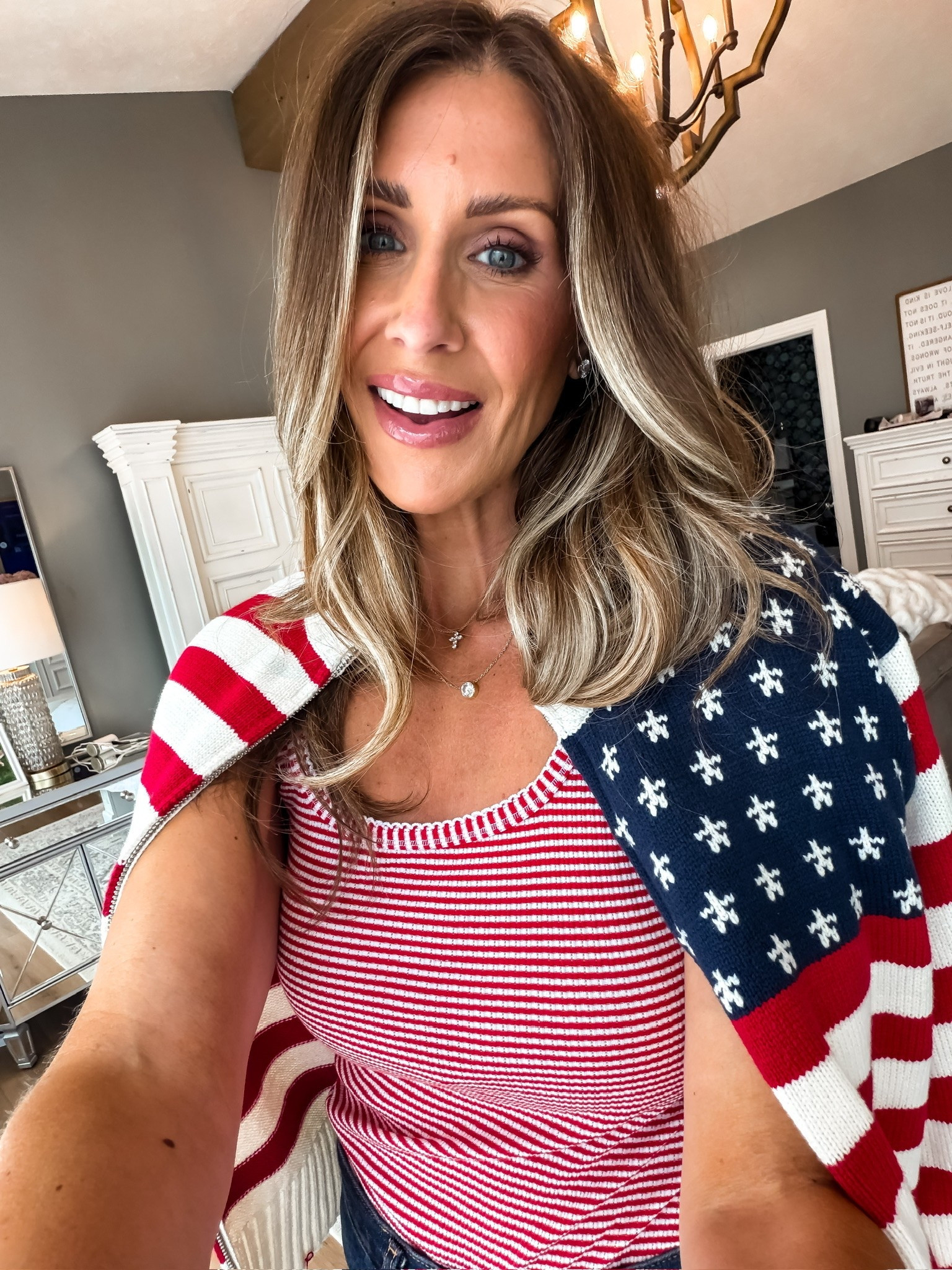 Love this patriotic knit look for summer holidays, backyard BBQs, and everything in between. The striped tank and American flag sweater are such a cute combo, and both pieces can be styled all season long.

patriotic outfit, Fourth of July outfit, American flag sweater, striped tank, summer style, holiday outfit, red white and blue, casual chic, summer fashion, weekend outfit, patriotic fashion, BBQ outfit, summer layering, themominstyle

#LTKootd #LTKSeasonal #LTKOver40