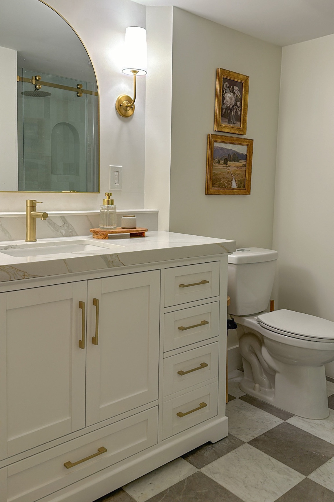 Master Bathroom Remodel!! Basically everything in this picture is linked! 

White bathroom - gold bathroom - checkered tile floor - wall sconces - arch mirror - wall art - arch shower niche 

#LTKstyletip #LTKU #LTKhome
