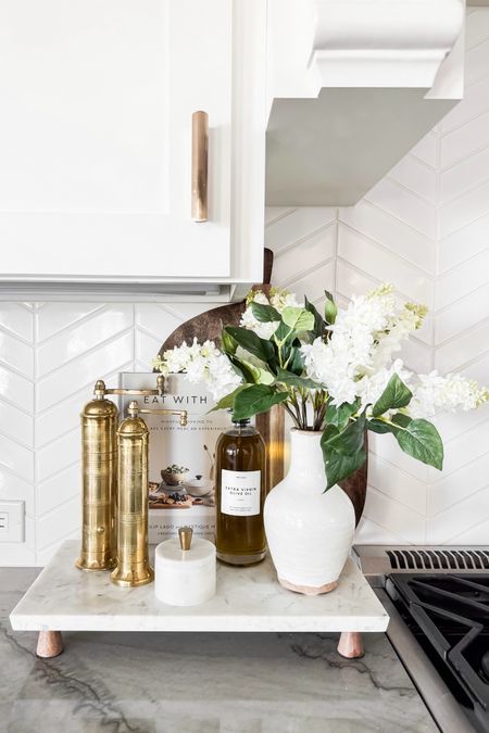 I am loving this kitchen counter refresh - perfect for the spring season!

Home  Home decor  Home favorites  Spring home  Spring home decor  Kitchen  Kitchen essentials  Faux florals  Marble  Footed board  Salt and pepper mills  Cookbook  Glass dispenser  Vase  Salt cellar  ourpnwhomee

#LTKSeasonal #LTKhome
