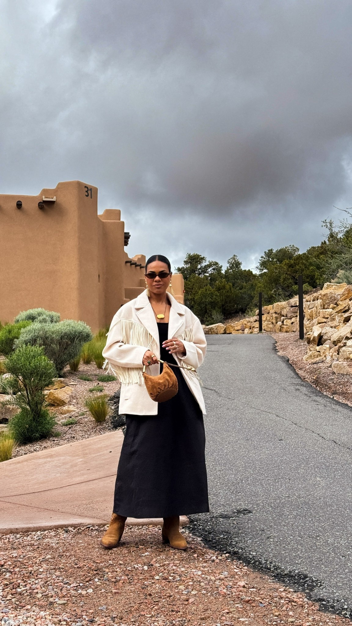 Black dress w/ oversized fringe rodeo jacket, gold & brown handbag, suede boots, gold pendant necklace & sunglasses. 
 

#LTKOver40 #LTKStyleTip
