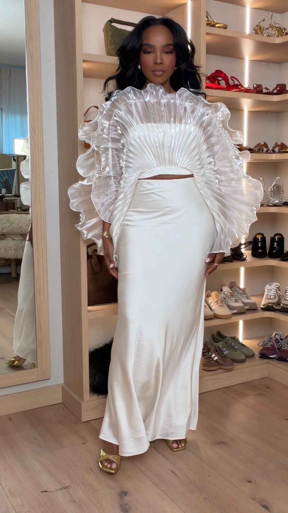 Cost per wear drops fast with a statement set like this — timeless white, elevated texture, and a silhouette you’ll keep reaching for season after season.

This dramatic ruffle top paired with a sleek satin skirt is the definition of modern elegance. It’s one of those outfits that instantly looks high-end and memorable, whether you style it together or mix each piece separately for maximum versatility.

Perfect for holiday parties, NYE celebrations, engagement photos, winter weddings, cocktail events, and formal nights out.

📏 Fit + Details:
• Ruffle statement top — structured with volume, true to size, lightweight organza feel  
• Satin maxi skirt — true to size, smooth drape, comfortable and flattering through the hips  

📏 Sizing: Size Small  
📏 Measurements: 5’4” · 138 lbs · 34D · 27” waist · 40” hips  

Styled multiple ways, statement white outfit, holiday occasion wear, NYE white outfit ideas, satin maxi skirt, dramatic ruffle top, elevated formal looks, long-term wardrobe investment.

Follow me on Instagram and YouTube @kirasfashionfinds

#LTKootd #LTKgrwm