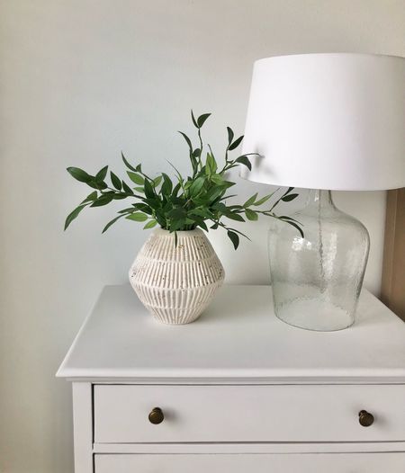These nightstands are such a great price! I did paint them with chalk paint and sealed them with wax. Everything is linked.


White nightstands, lamps, coastal lamps, glass lamp, lampshades, stems, faux stems, vases, coastal homes, home decor, nightstand decor 

#LTKhome #LTKFind
