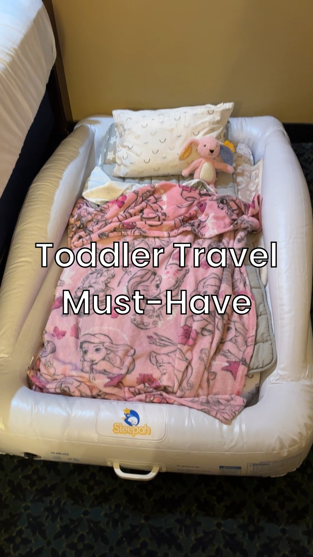 Traveling with a toddler? This is my #1 hotel hack.
If you’ve ever tried to share a bed with a wiggly two-year-old, you know it’s game over for everyone’s sleep. We stay in hotels pretty often, and most are standard 2-queen rooms, which means without this, bedtime can be… interesting.

This inflatable toddler bed has been a total lifesaver. It inflates and deflates in seconds, packs down small enough to fit in a suitcase, and sits perfectly on the floor next to our beds. My toddler sleeps like a dream in it, which means we actually get to sleep too.

Parents, bring this on your next trip and thank me later. 😘