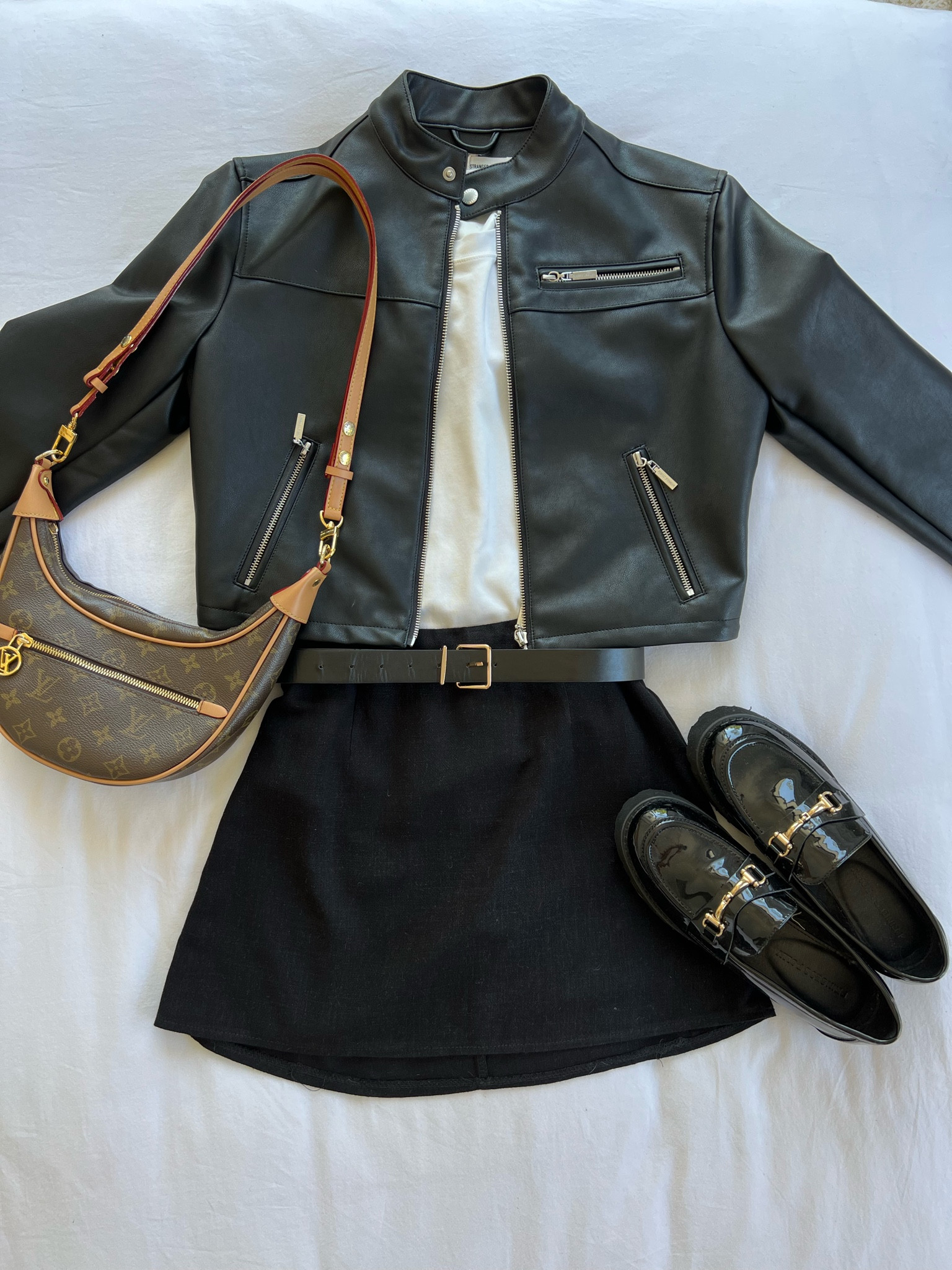 Neutral everyday fit for spring - black mini skirt, white Uniqlo top, loafer shoes, perfect stranger leather biker jacket  