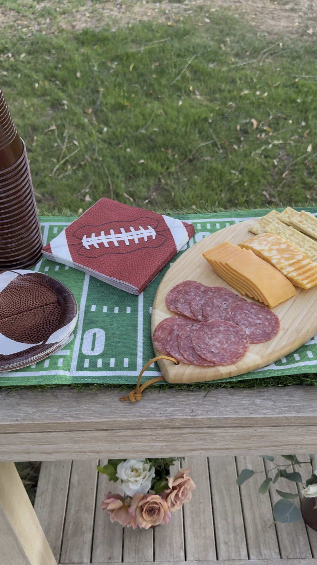 My outdoor console table adorned with football tailgate must haves! You’ll love this football shaped charcuterie board, football cups, napkins, vases, a touchdown table runner and more!! This is perfect for Friday night football (Friday night lights // high school football), Big Noon Kickoff (college football), Sunday Night Football, Monday night Football, the NCAA playoffs, the NFL playoffs, the Super Bowl and more! ❤️🏈 

#LTKSeasonal #LTKHome #LTKParties