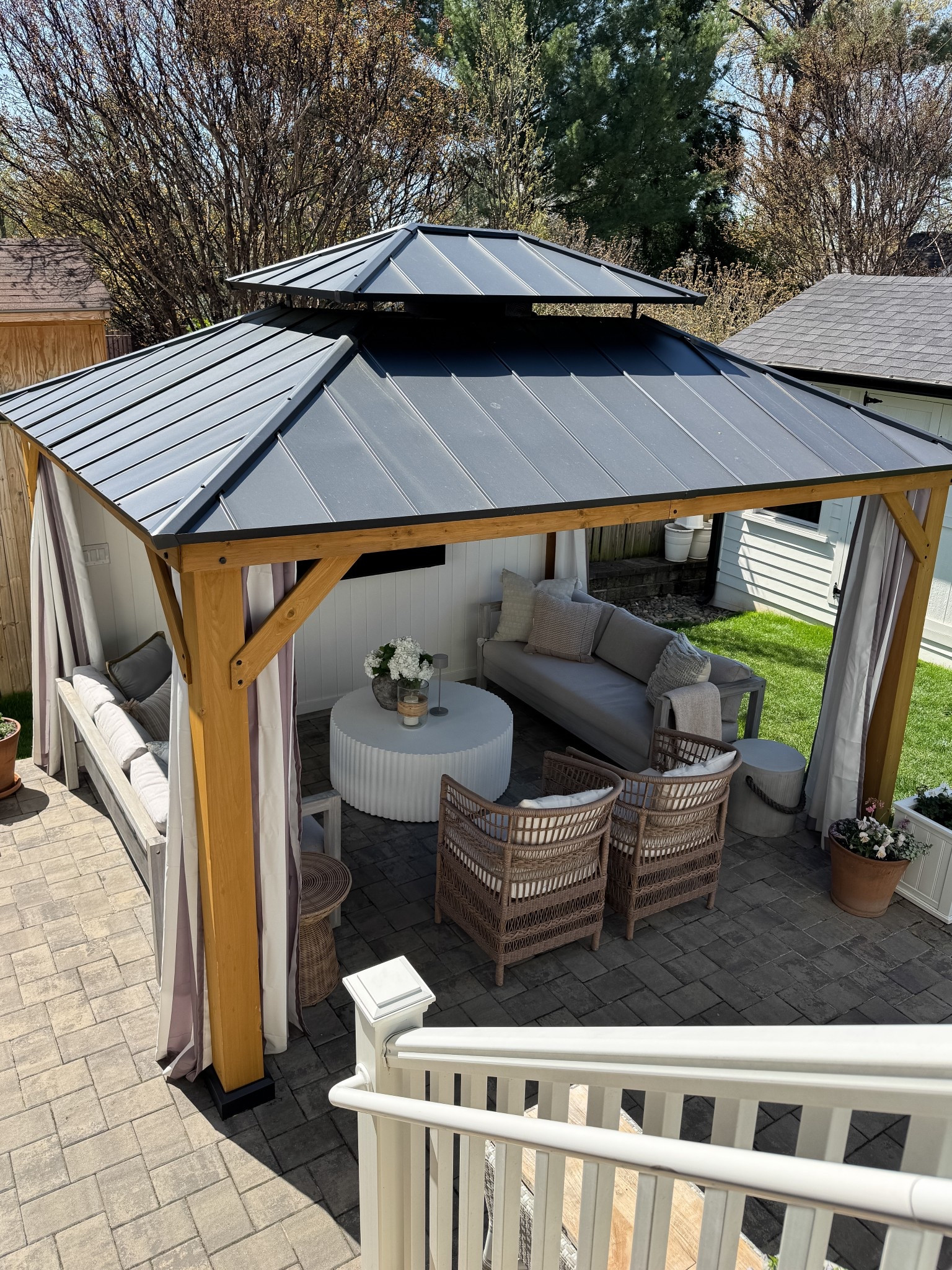 Last year we built this prefabricated gazebo for our backyard. We get constant sun in our backyard without any shade so we roast during the spring & summer! We upgraded the gazebo by building a shiplap wall and installing a TV, lights and a fan. Now we are looking forward to hosting our family here for Easter.

#LTKStyleTip #LTKSaleAlert #LTKHome