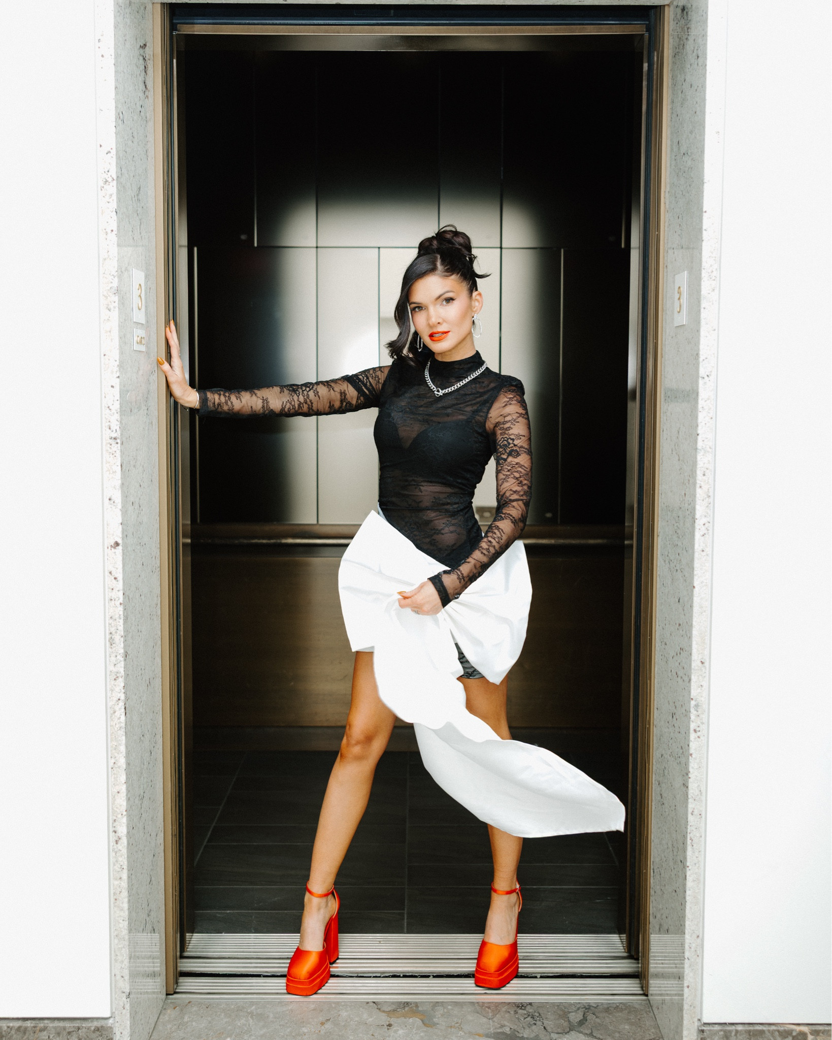 Wrapped mini dress by Akira platform red heels Kendra Scott jewelry 