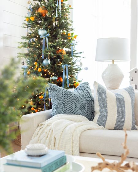 A peek at our citrus Christmas tree in our coastal living room! Includes our 9’ prelit Christmas tree decorated with orange stems, blue velvet bows, a blue and white striped rug, linen sofas, raffia coffee table, cane box, cableknit pillow covers, velvet pillows, a white ceramic Christmas Village and Frame TV. Several items are on sale too! See more of my citrus Christmas decor here: https://lifeonvirginiastreet.com/citrus-christmas-decor/.
.
#ltkhome #ltkholiday #ltksalealert #ltkstyletip #ltkfindsunder50 #ltkfindsunder100 #ltkcyberweek #ltkover40 #ltkseasonal

#LTKHoliday #LTKhome #LTKSeasonal