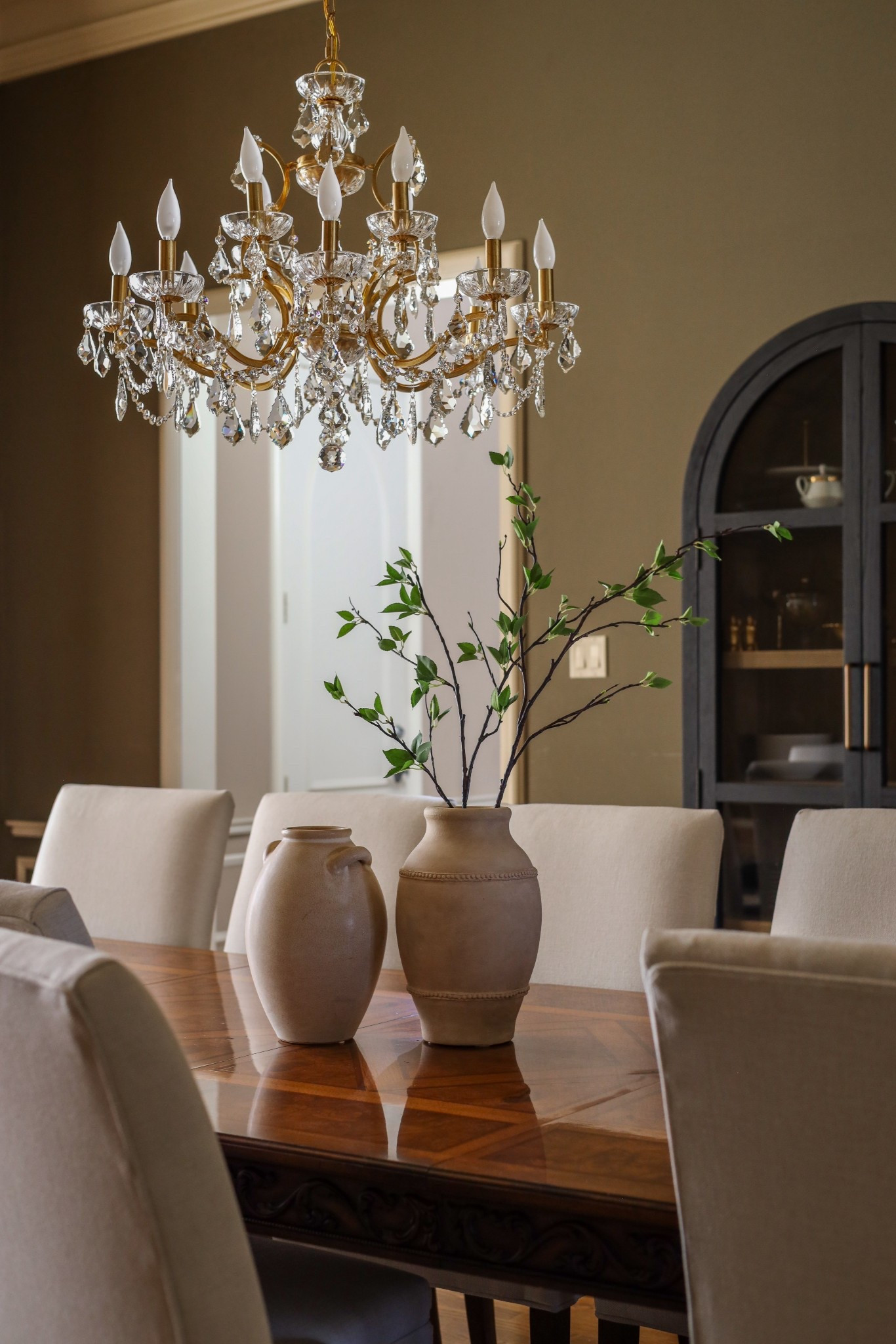 Crystal chandelier, gold chandelier, dining room decor, black arched cabinet. 

#LTKHome