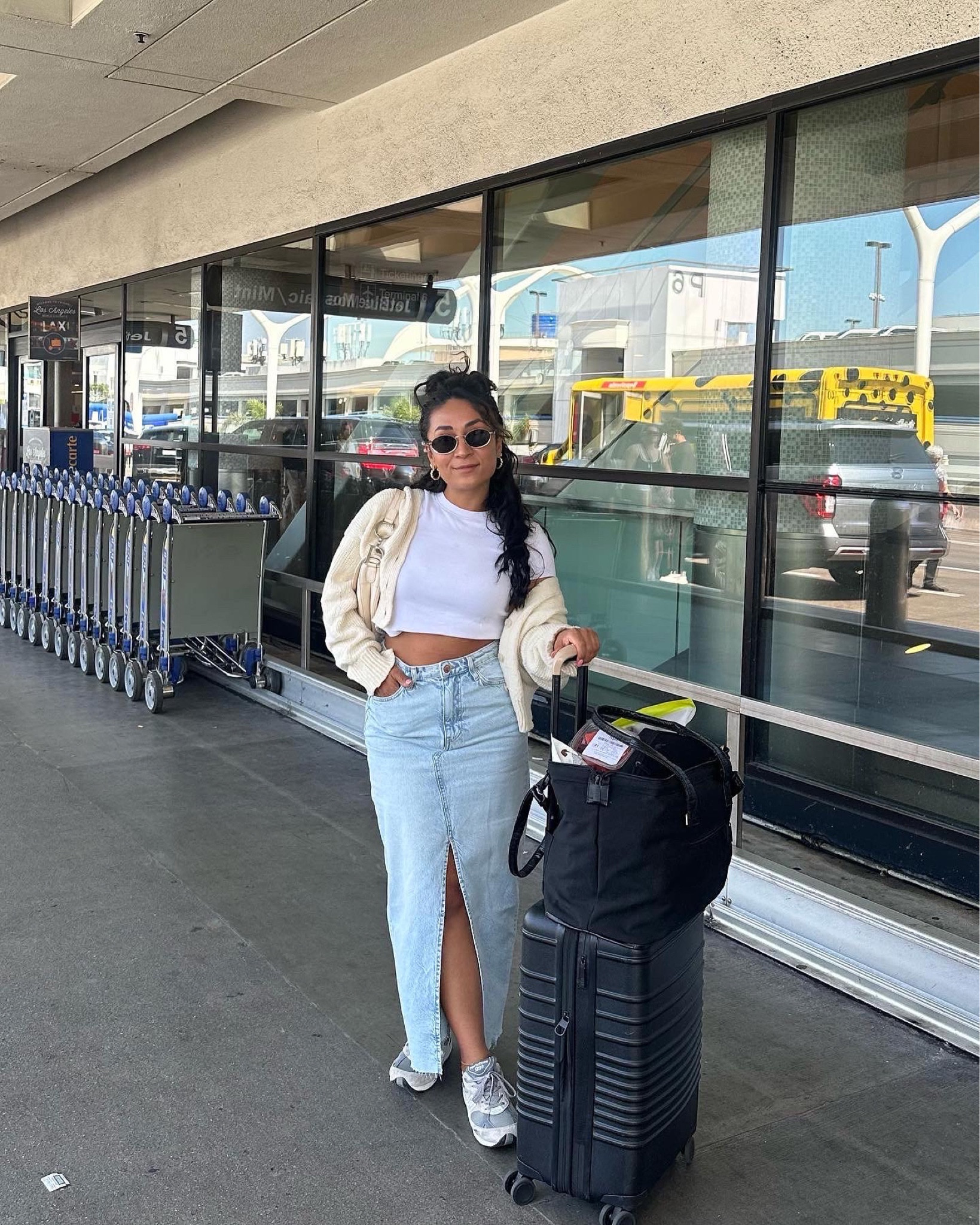 Super comfy and chic airport outfit. The comfiest hm denim skirt and sneakers also with my beis luggage. 

#LTKtravel