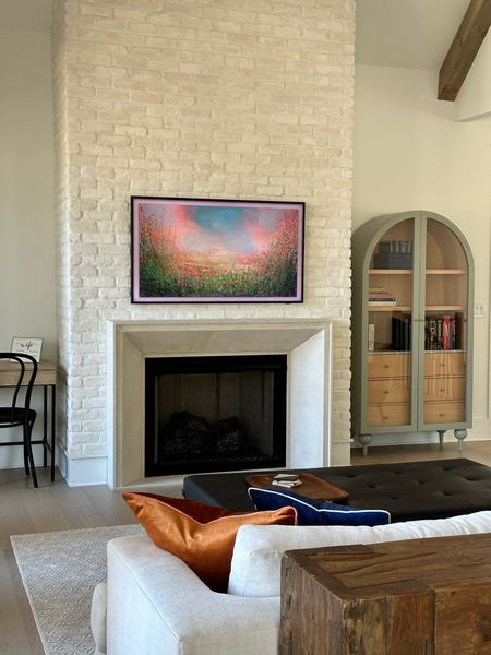 Living Room Design | Brick Veneer Fireplace | Frame TV | Media Cabinet | Desk | Sofa | Pillows | Ottoman | Coffee Table | Console Table

#LTKhome #LTKstyletip