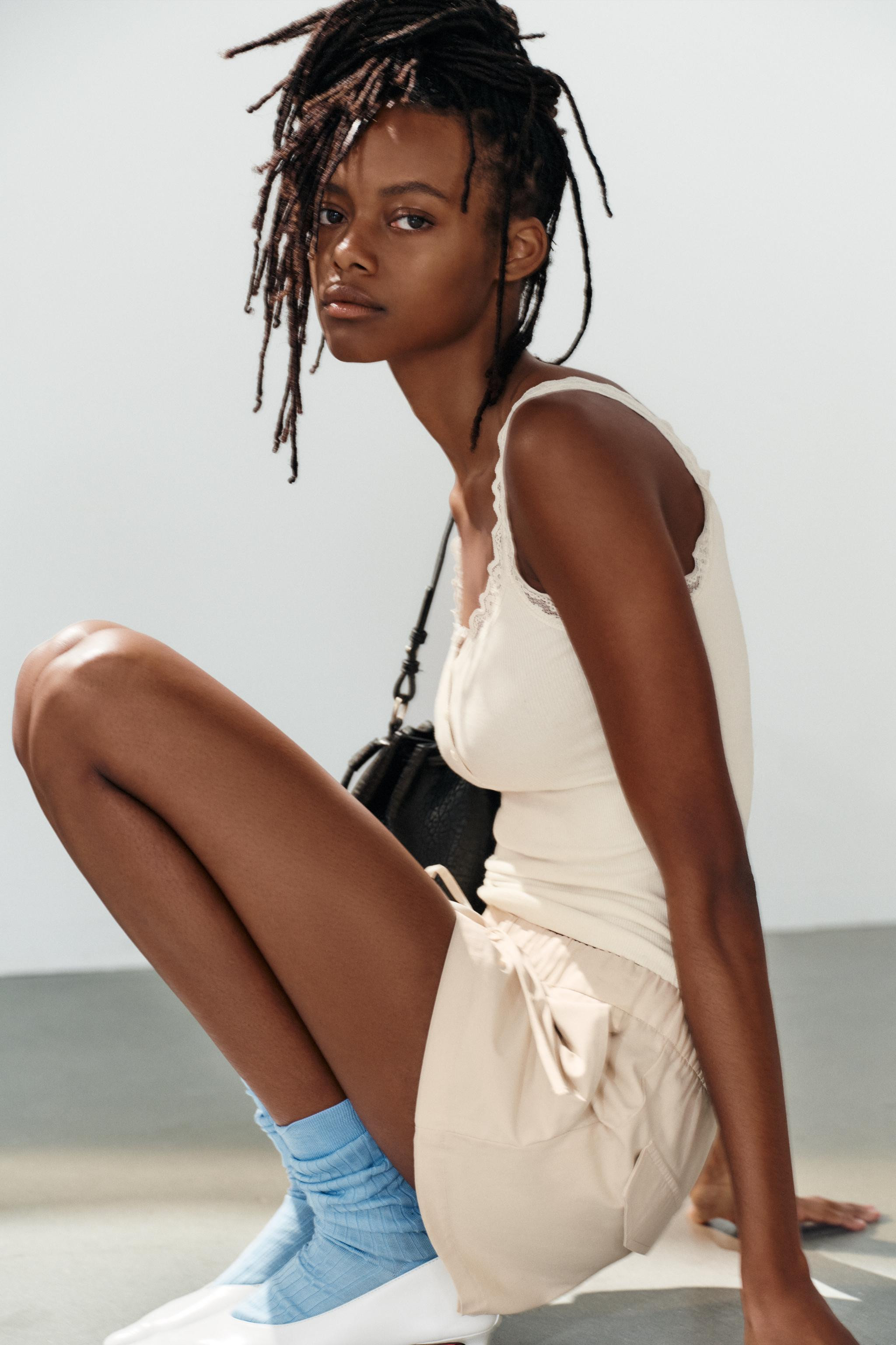 Top featuring a 48% linen blend main fabric. Round neckline with a buttoned placket. Wide straps. | Zara UK